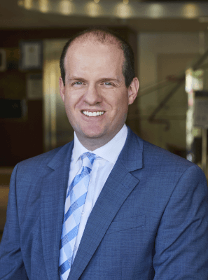 man smiling with necktie and suit